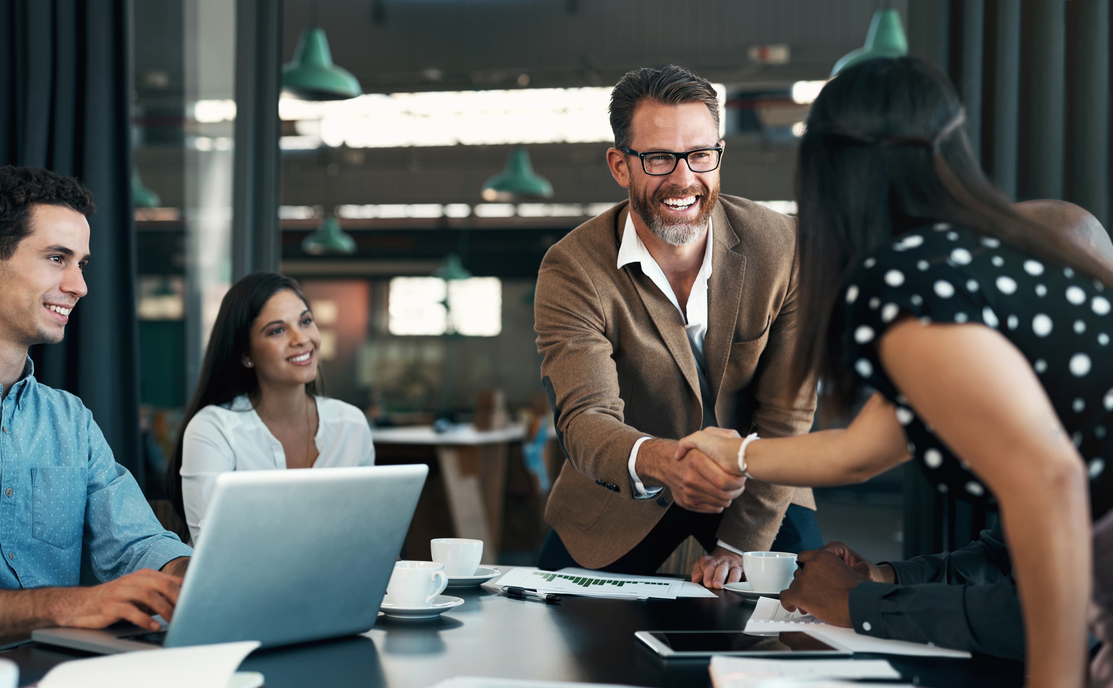 Business professionals shaking hands in meeting